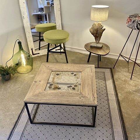 Dans cette photo, il y a plusieurs exemples des créations de Sabine : table, lampes, miroir et petit mobilier.